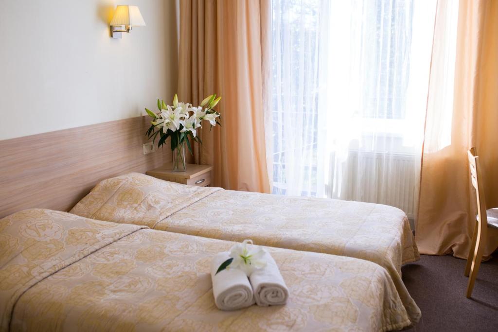 Postel nebo postele na pokoji v ubytování Hotel SPA Arkadia