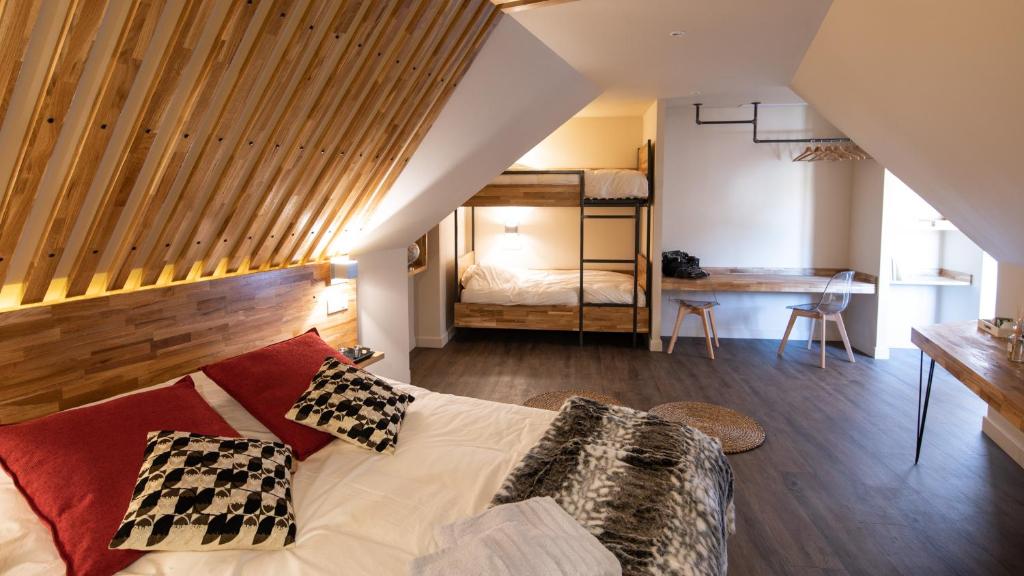 a bedroom with a bed and a bunk room at L'ORIGINE in Saint-Aubin