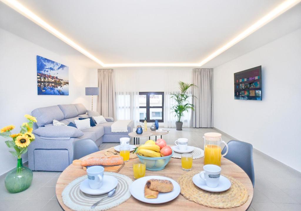 a living room with a table with food on it at Loft El Charco De San Ginés in Arrecife