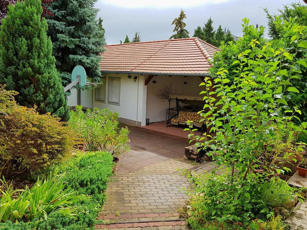 a small white house with a pathway leading to it at Zámor 10 Apartmant in Keszthely