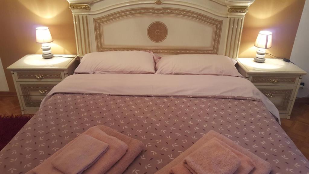 a bedroom with a large bed with two night stands at B&B in Arena L' Opera in Verona