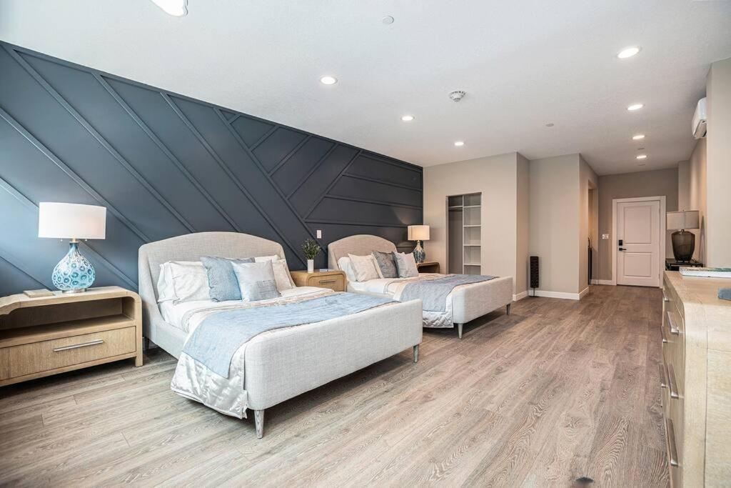 a bedroom with two beds and a large wall at Private Room, Kitchen & Bathroom 2 in Bradenton