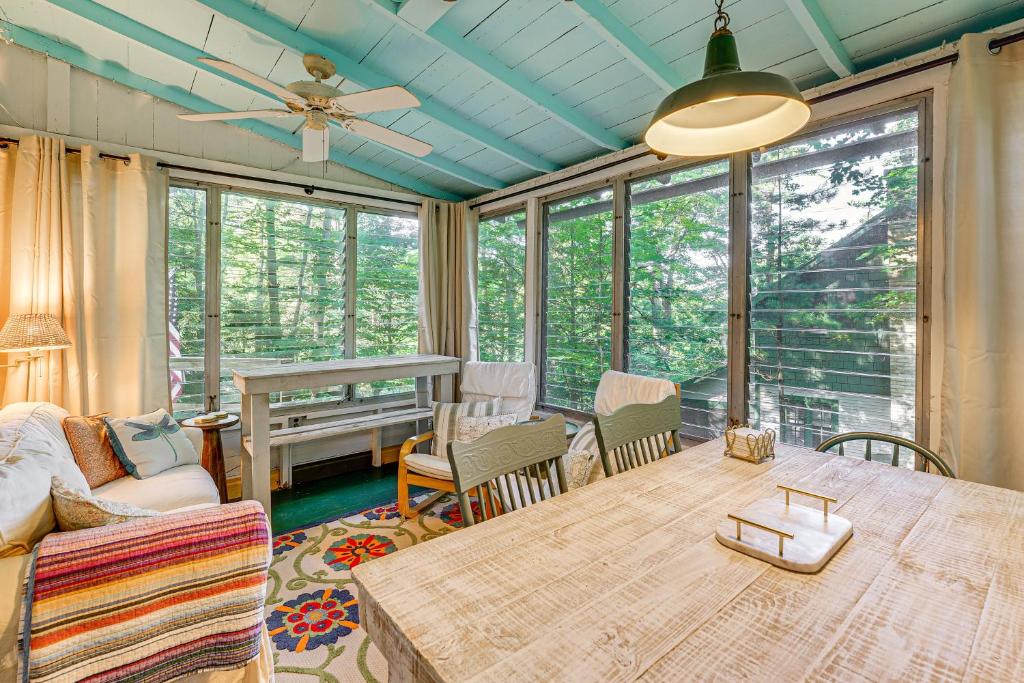 a living room with a table and chairs and a couch at about 1 Mi to Dtwn Grand Haven Lake Michigan Cabin in Grand Haven