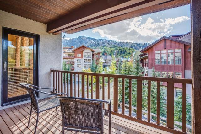 a balcony with a chair and a view of a city at First Tracks Townhome in Solitude