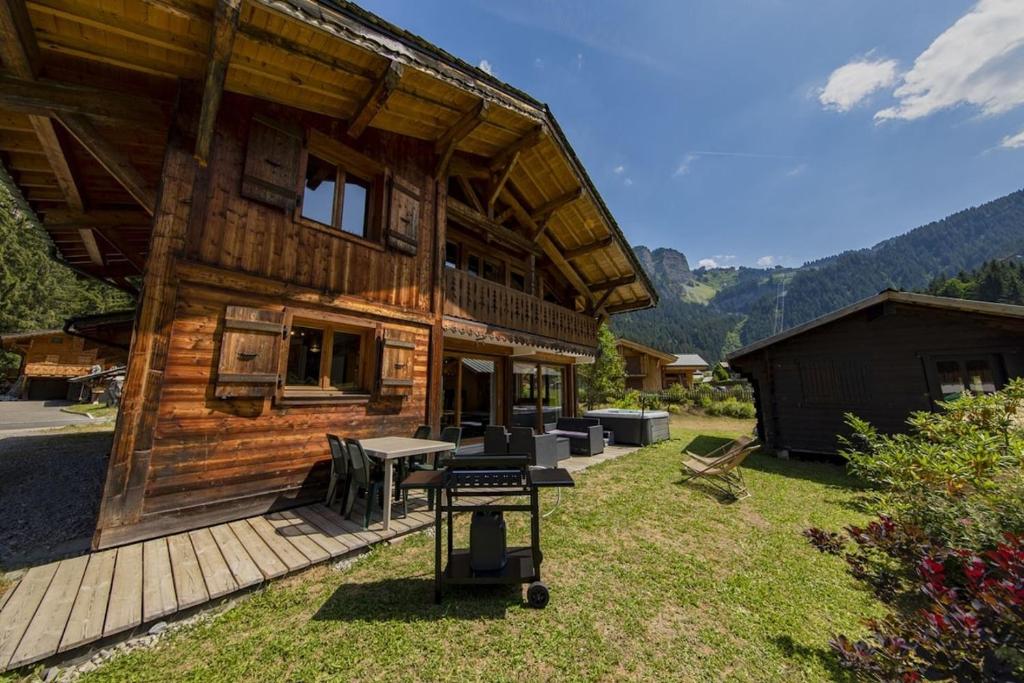 une cabane en rondins avec une table de pique-nique devant elle dans l'établissement Chalet Hauts Forts Prodains Mountain Voyages, à Morzine