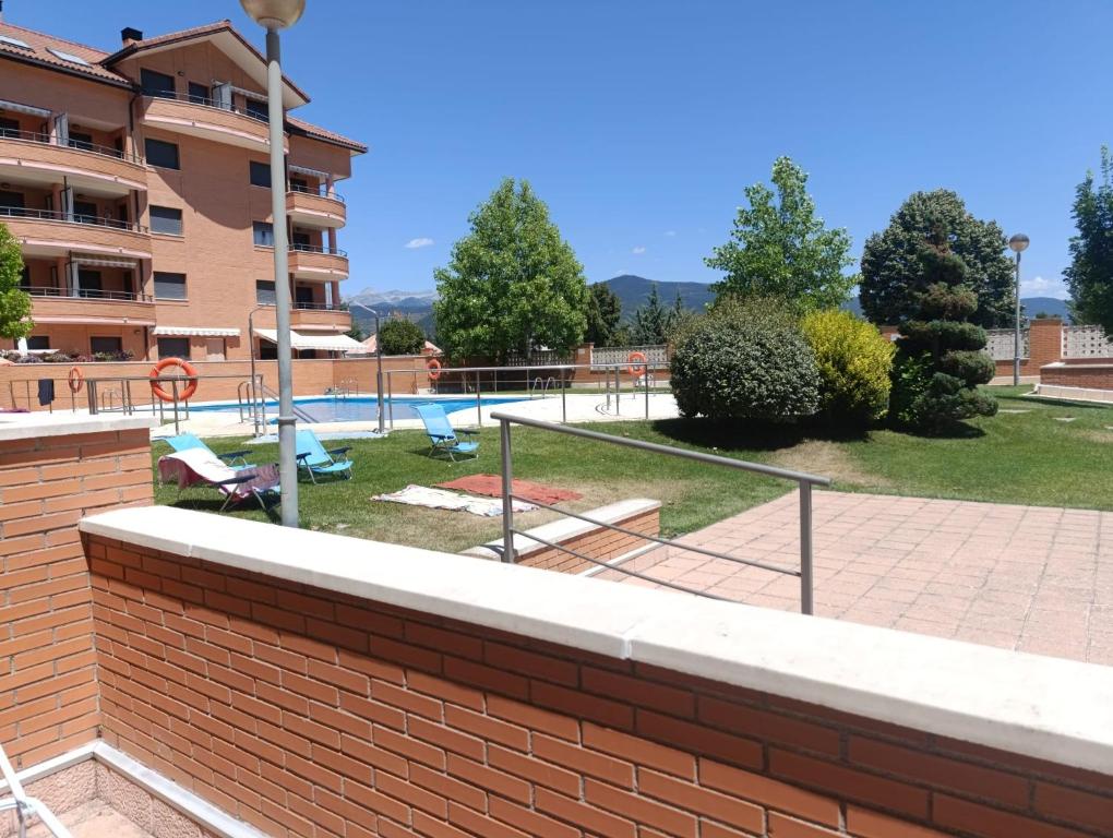 a brick wall next to a swimming pool at Apartamento Montecanal 5 in Jaca