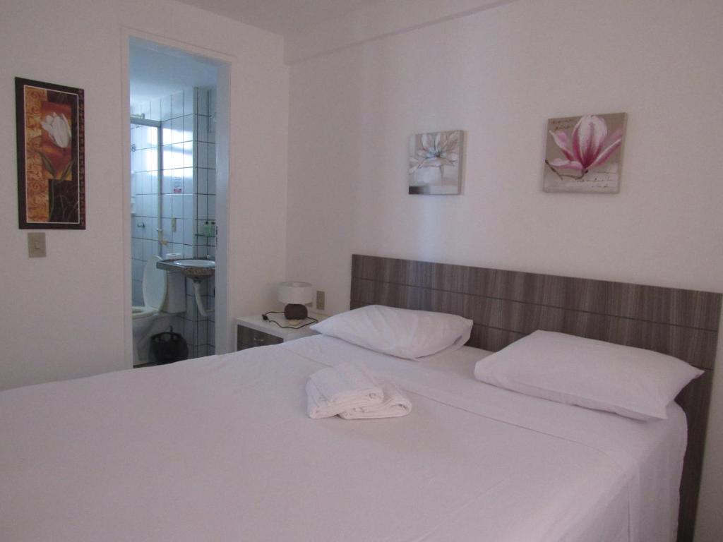 En eller flere senge i et værelse på Residencial em Meireles