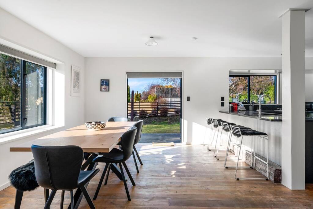 a kitchen and dining room with a table and chairs at Stonehaven in Wanaka