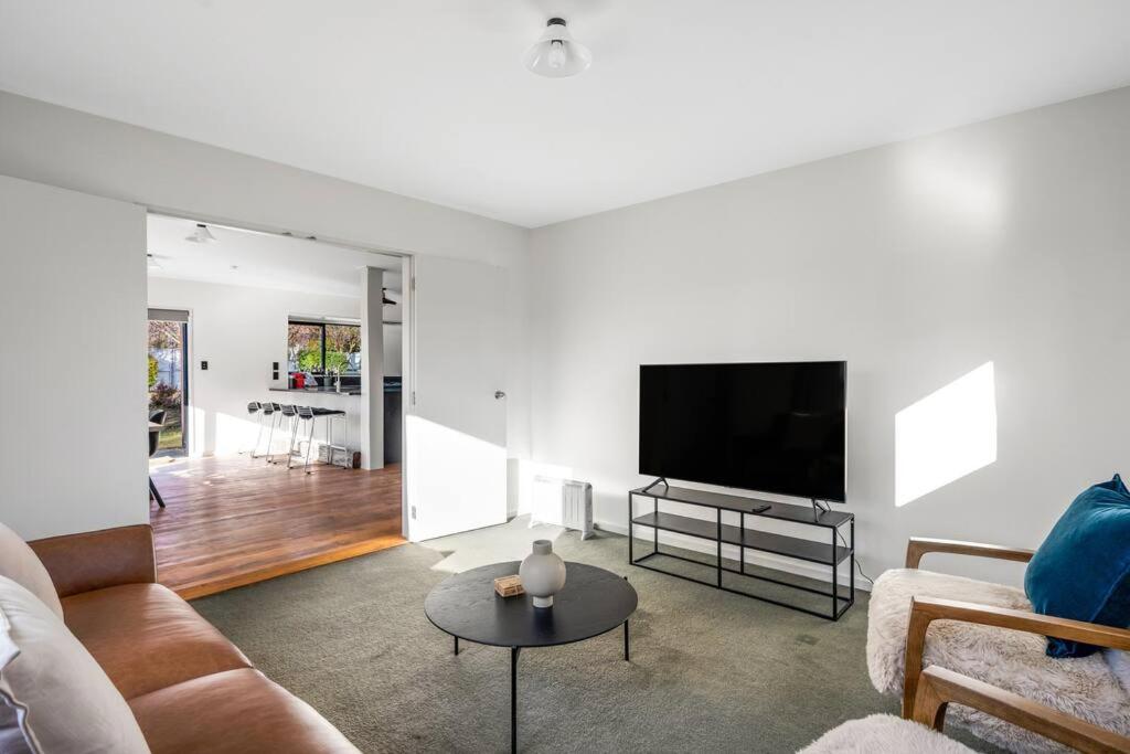 a living room with a couch and a flat screen tv at Stonehaven in Wanaka