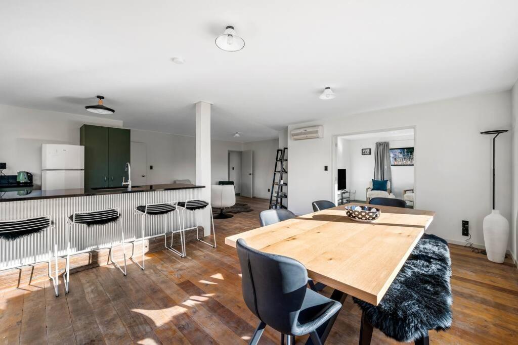 a kitchen and dining room with a wooden table and chairs at Stonehaven in Wanaka