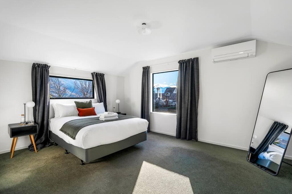 a bedroom with a bed and a large window at Stonehaven in Wanaka