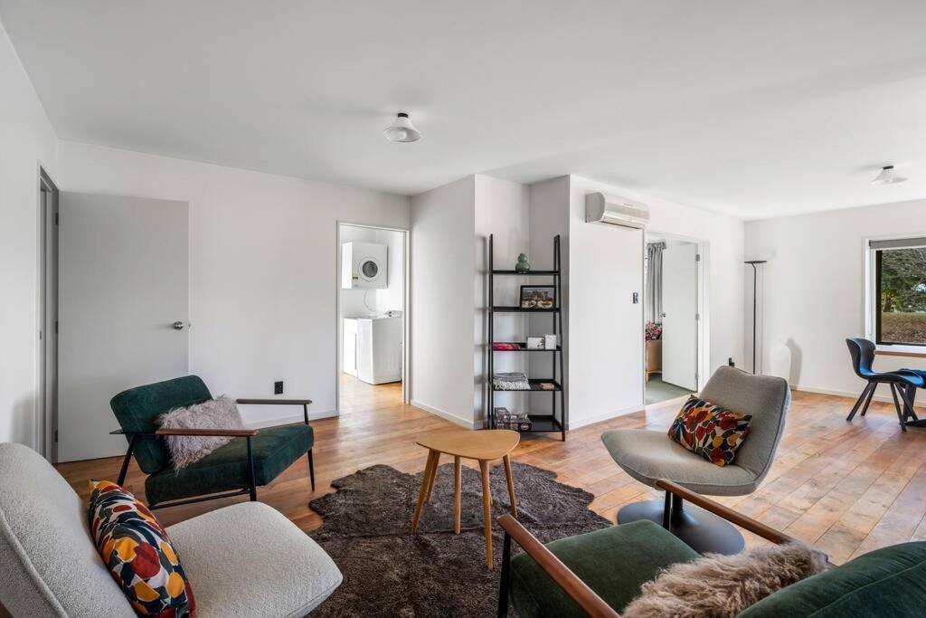 a living room with several chairs and a table at Stonehaven in Wanaka