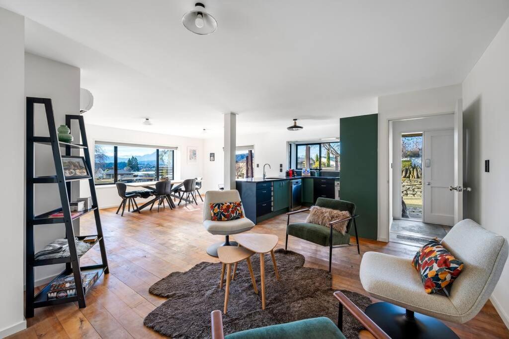 a large living room with chairs and a table at Stonehaven in Wanaka