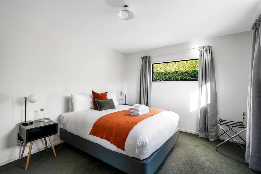 a bedroom with a large bed and a window at Stonehaven in Wanaka
