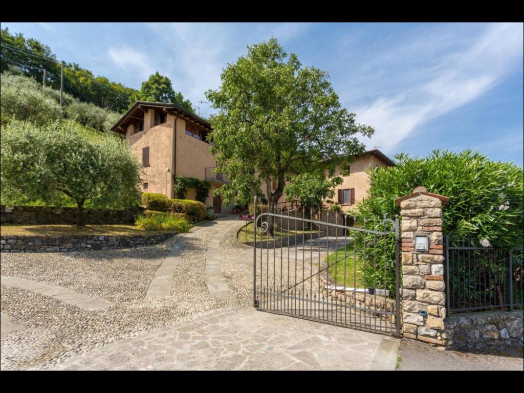 an entrance to a house with a wrought iron gate at B&B Ronco degli Ulivi in Iseo