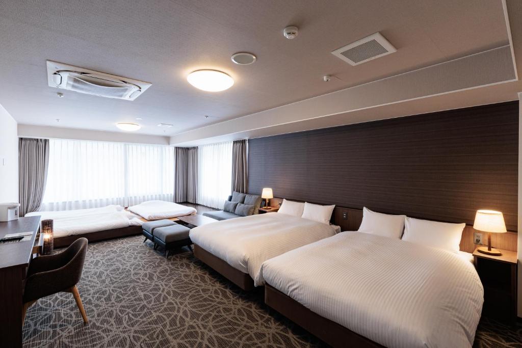 Postel nebo postele na pokoji v ubytování Hotel Silk Tree Nagoya