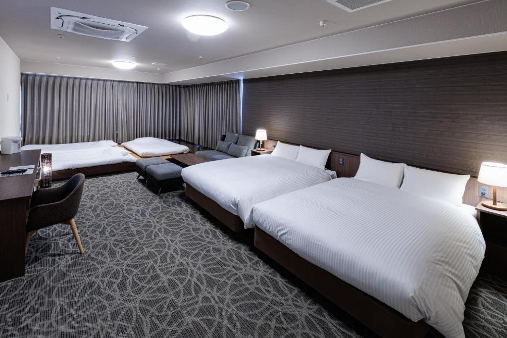 Postel nebo postele na pokoji v ubytování Hotel Silk Tree Nagoya
