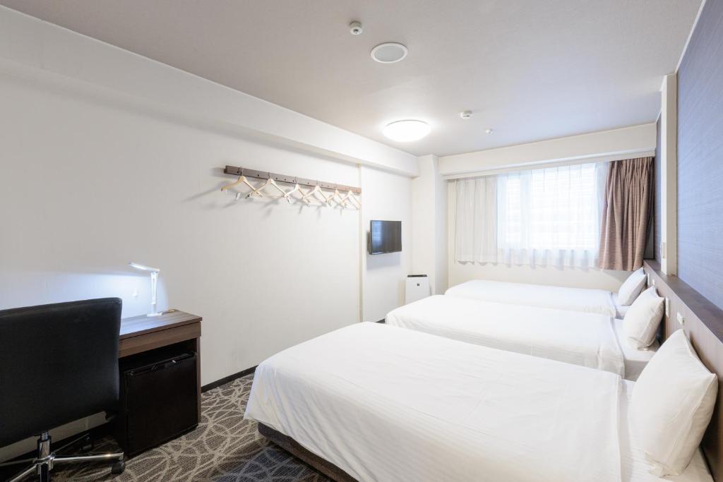 Postel nebo postele na pokoji v ubytování Hotel Silk Tree Nagoya