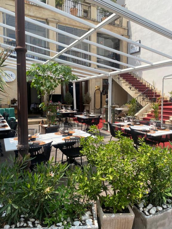 an outdoor patio with tables and chairs and a building at Apartamente Arcul de Triumf in Bucharest