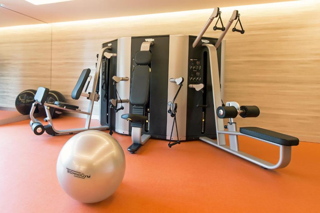 A compact gym contains resistance equipment, a bench and a stability ball.