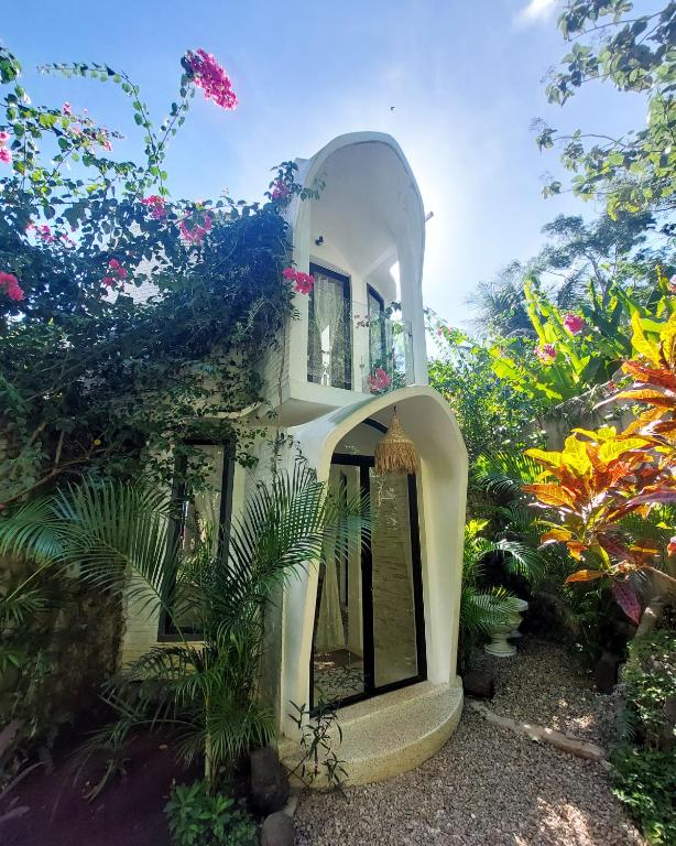 a white building with plants in front of it at OMA WATU DOME VILLAS in Pacitan