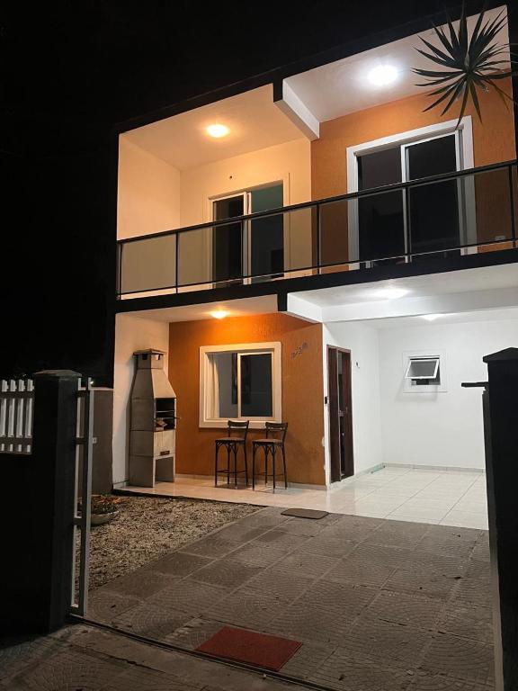 a apartment building with a balcony and a table at Residencial Passos 1 in Guaratuba