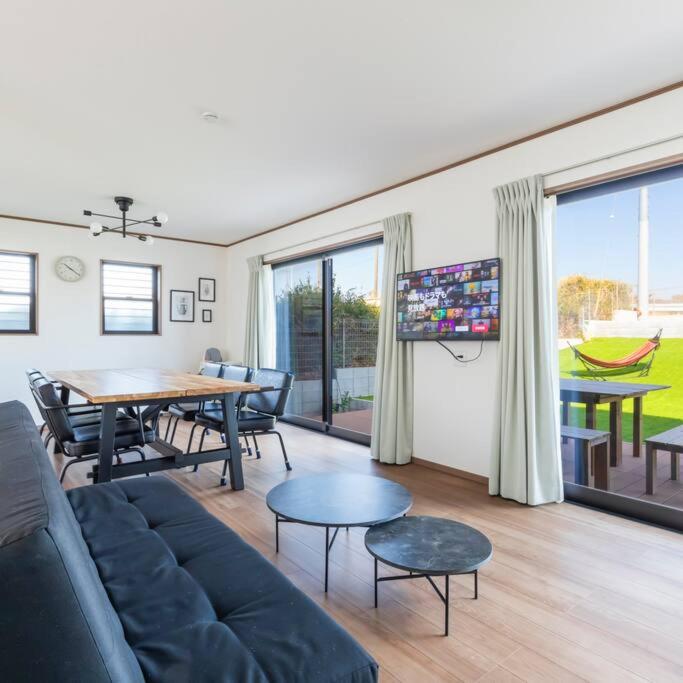 a living room with a couch and a table at 三浦海岸 SealightVilla A棟 in Miura