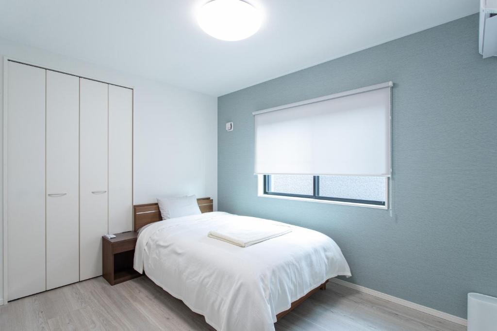 Postel nebo postele na pokoji v ubytování Mova Villa Ozu