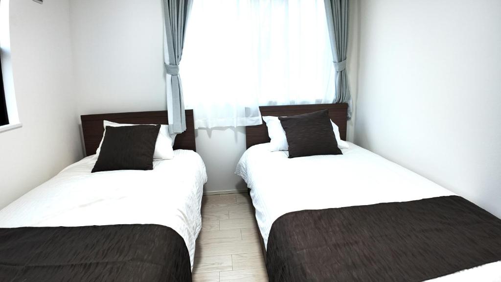 Postel nebo postele na pokoji v ubytování Daiichi House