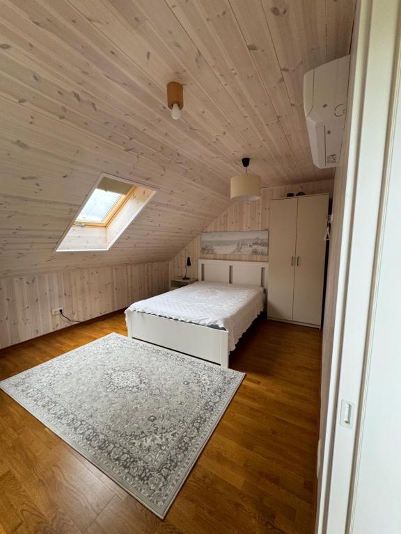 a bedroom with two beds and a skylight at Kopa Cabana in Palanga