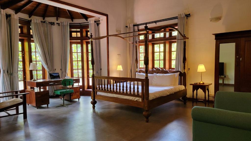 a bedroom with a canopy bed and a piano at Pinnacle of Everything in Kandy