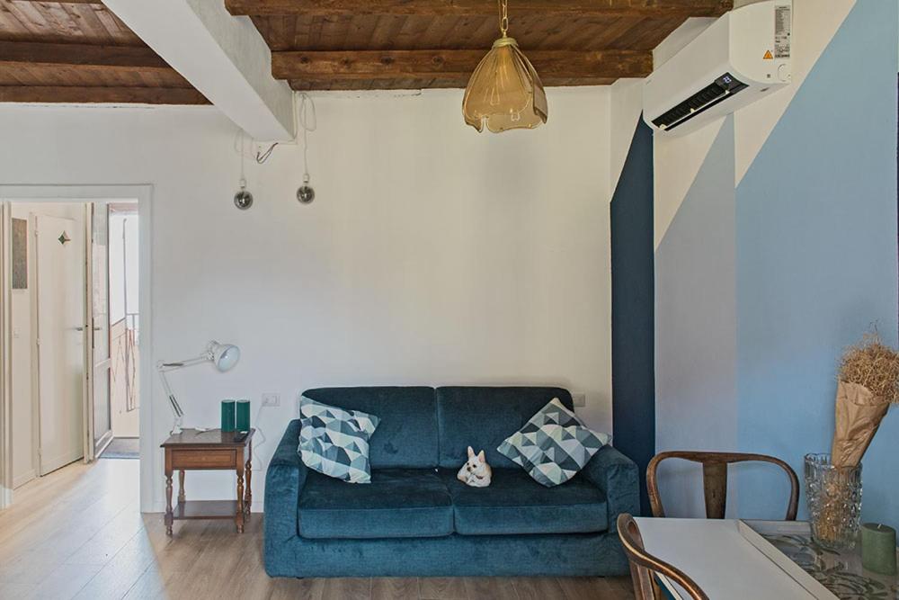 a living room with a blue couch and a table at LevOasi 9 - Lake and mountains escape in Levo