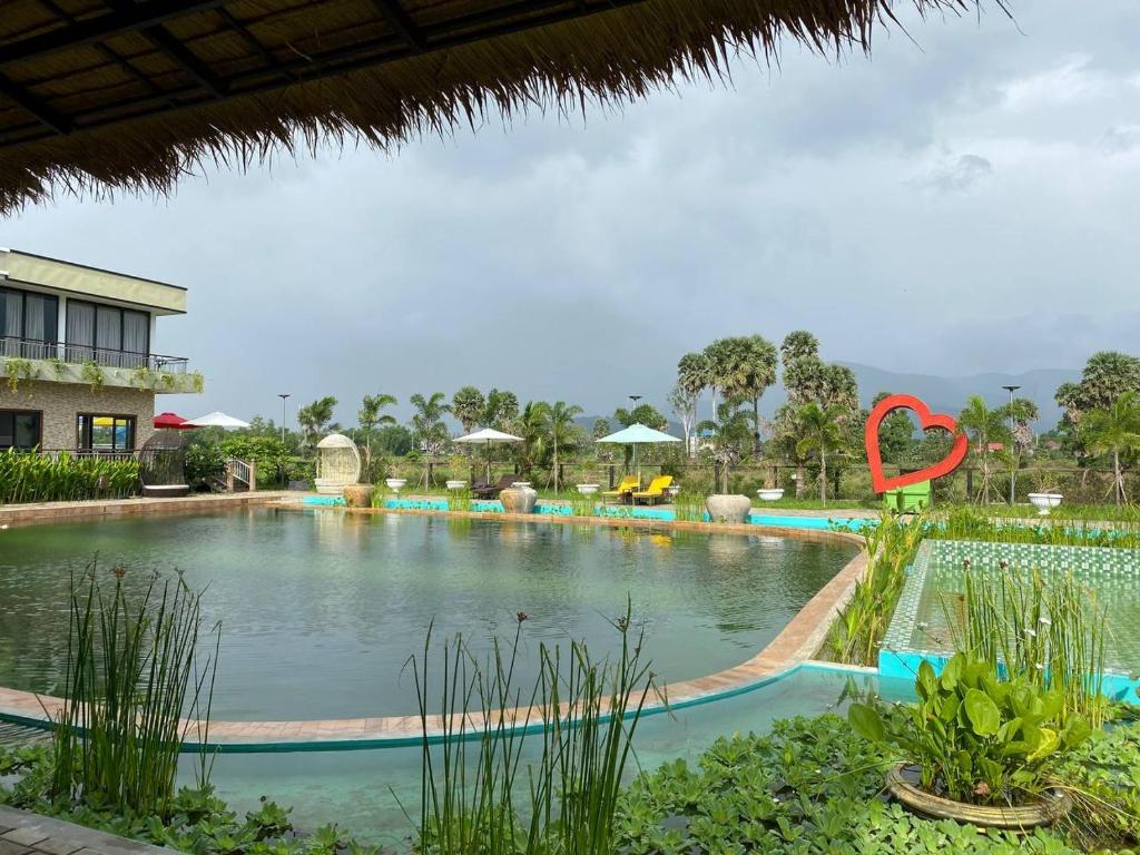 a swimming pool at a resort with a large swimming pool at Ganesha Kampot Resort in Kampot