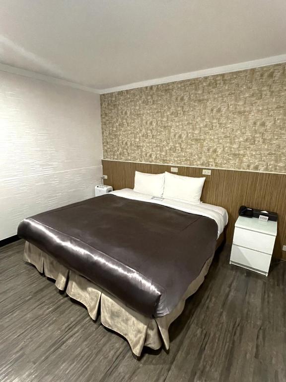 Postel nebo postele na pokoji v ubytování Ximen Hotel
