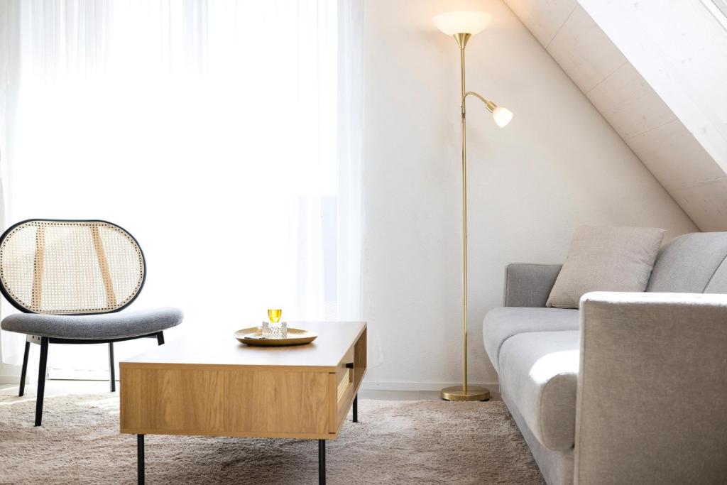 a living room with a couch and a table at STAYY Flagship Limmattal - contactless check-in in Schlieren