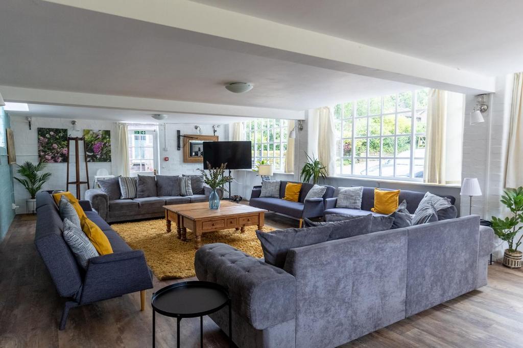 a large living room with couches and a tv at The Coach House in Lea