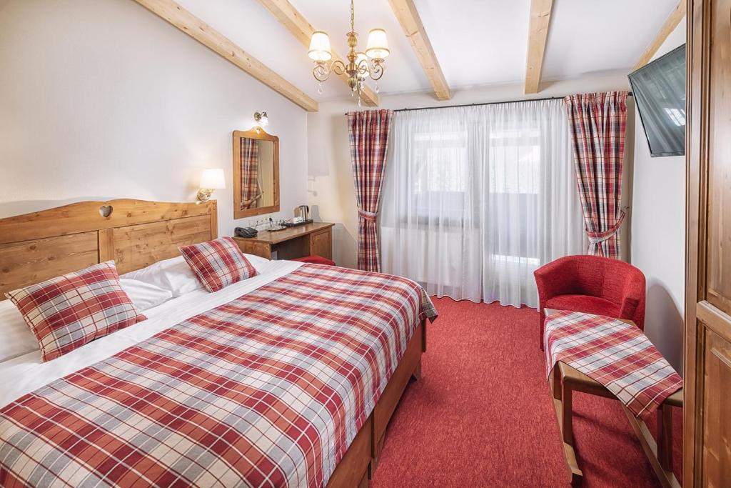 Postel nebo postele na pokoji v ubytování Ski & Wellness Residence Družba