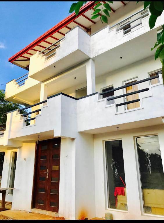 a white house with a red roof at Yarra BUNKZ Kandy in Kandy