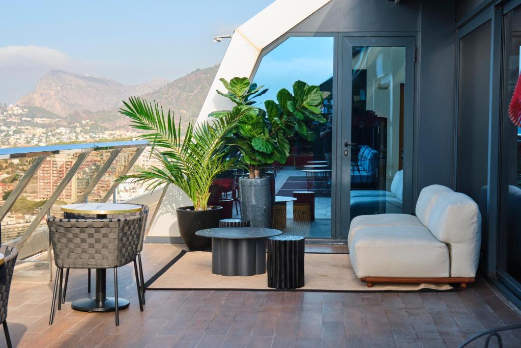 a balcony with a white chair and a table at ESTIMAR Calpe Suitopia in Calpe