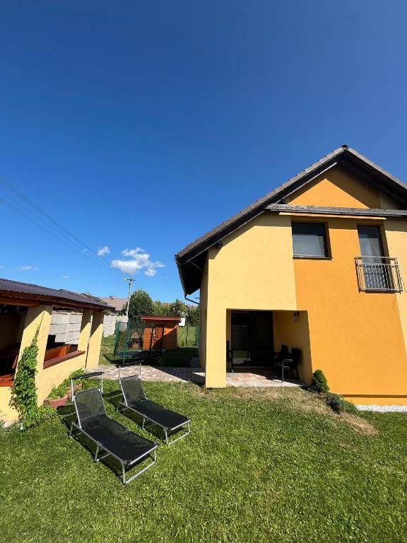 a house with two trampolines on the lawn at Ubytovanie v súkromí Horec in Liptovský Mikuláš