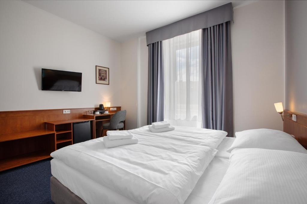 Łóżko lub łóżka w pokoju w obiekcie Hotel Beránek