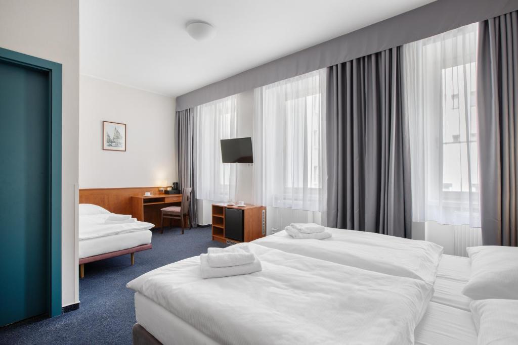 Łóżko lub łóżka w pokoju w obiekcie Hotel Beránek