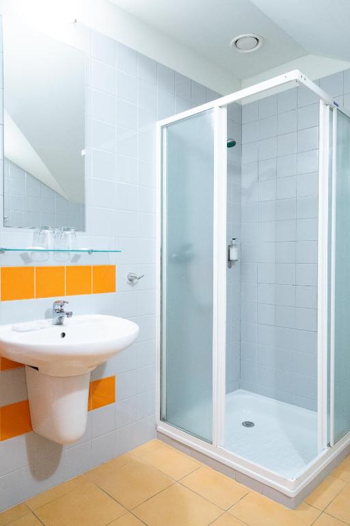 a bathroom with a shower and a sink at Nerija in Nida