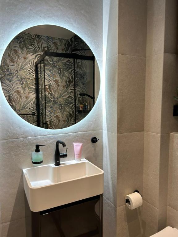 a bathroom with a sink and a mirror at Room with jungle bathroom in Dubrovnik