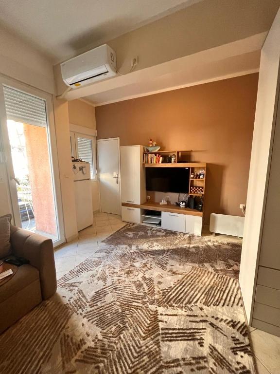 a large living room with a couch and a refrigerator at Apartment City in Tivat