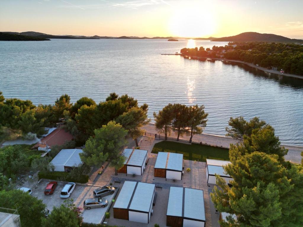 an aerial view of a lake with solar panels at Mobile House Pirovac Kamp Kerido in Pirovac