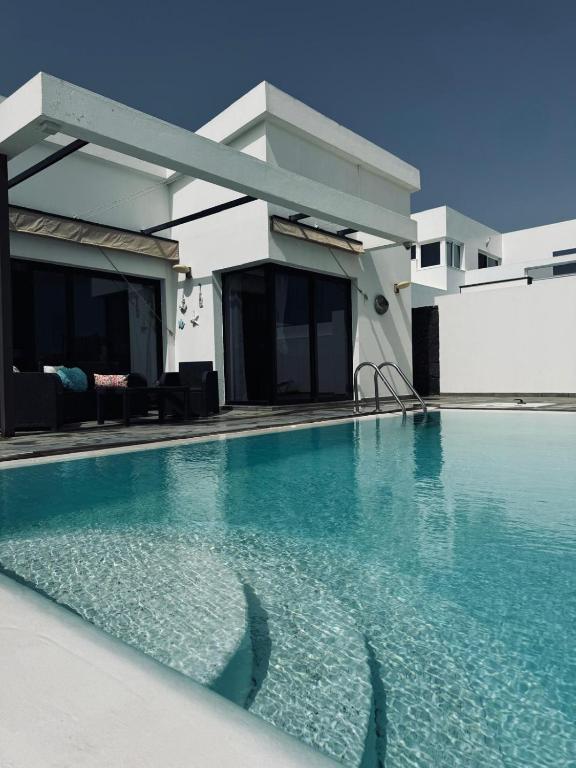a swimming pool in front of a house at Nazaret Home in Nazaret