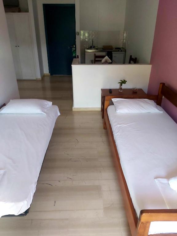 A bed or beds in a room at Filoxenia Hotel & Apartments