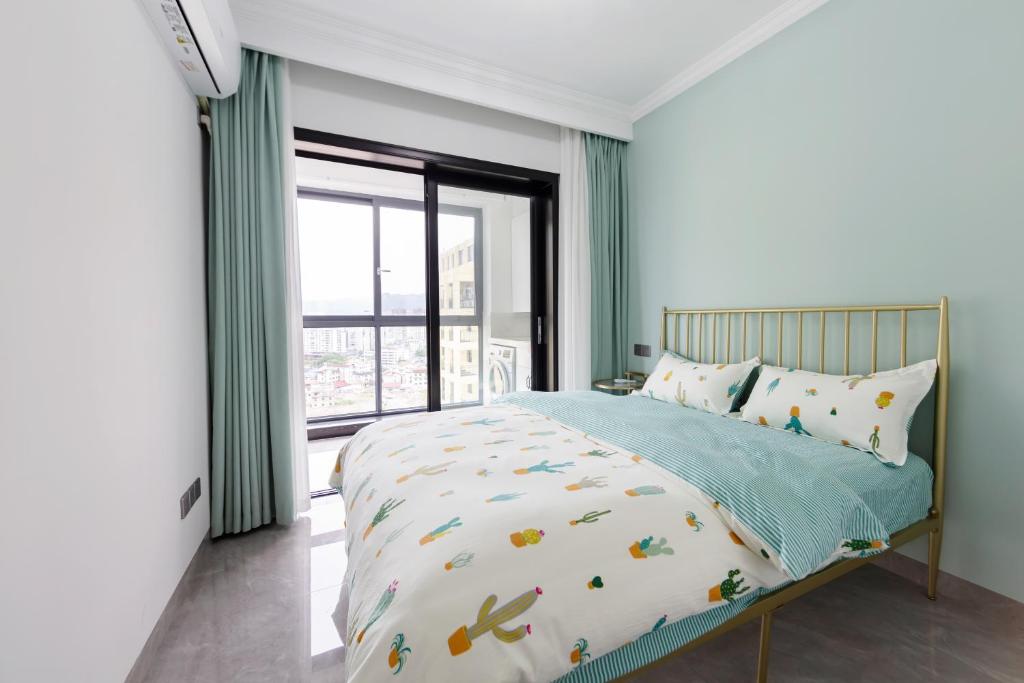 a bedroom with a bed and a large window at Heavens Gate homestay free pick up service from train station and airport in Zhangjiajie