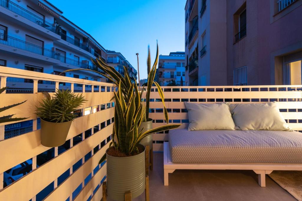 a bench sitting on top of a balcony with plants at K-DOCK by Nuka Homes in Jávea